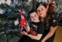Shawnee Milne and her son Barry, 7, won our elf on the shelf competition with their elf John.
