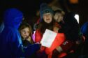 Carol singers at the Fintry Christmas lights switch on: a reminder of the true meaning of the season - and that Dundee will have much to celebrate in 2022. Photo: Kenny Smith/ DCT Media