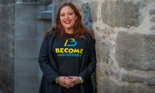 Lynn Erasmus wearing a Become Unstoppable tshirt in Perth's St Paul's Square.