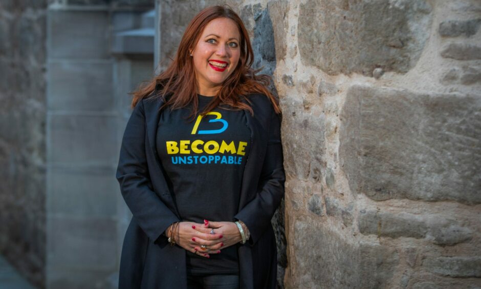 Lynn Erasmus wearing a Become Unstoppable tshirt in Perth's St Paul's Square.