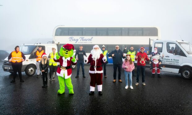 Santa Benarty volunteers dress up and drive the streets of Ballingry. Picture: Steve Brown.