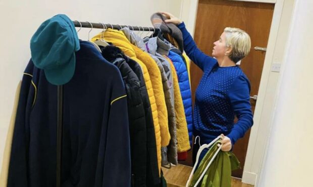 Co-owner Teri Devine with some of the donated jackets.