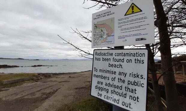 Signs warning of radiation at Dalgety Bay foreshore.