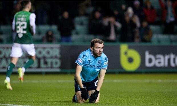 Paul McMullan dejected after his own goal.