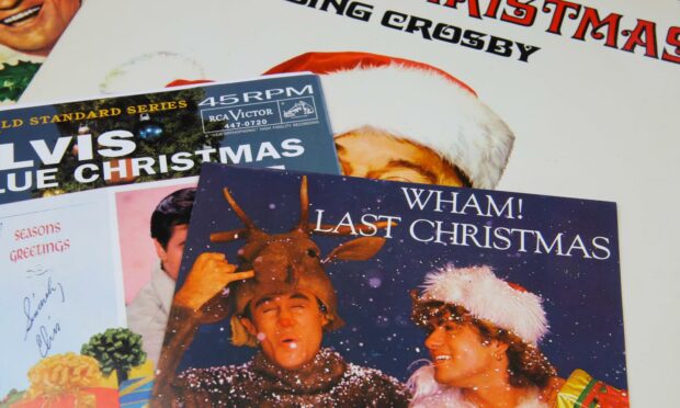Vintage vinyl record cover singles with famous Christmas songs. Image: Shutterstock