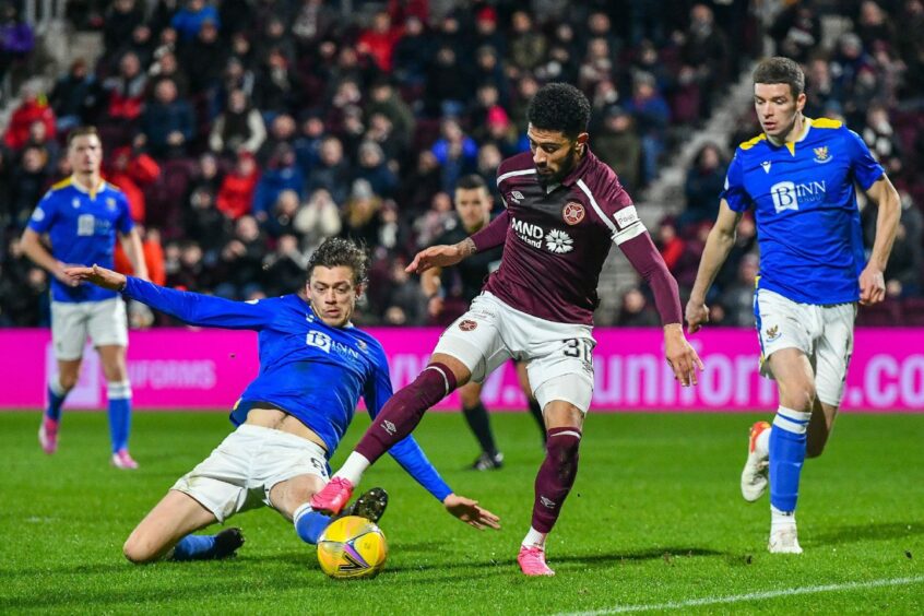 Murray Davidson tackles Josh Ginnelly during his side's recent dfeat to Hearts.