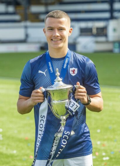Tait clutching the League 1 trophy