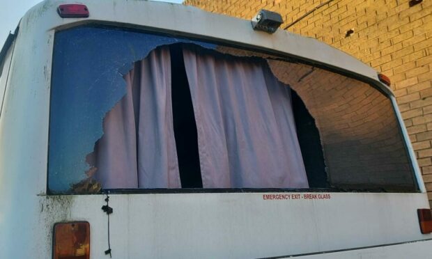 The broken bus window outside Dundee Museum of Transport.