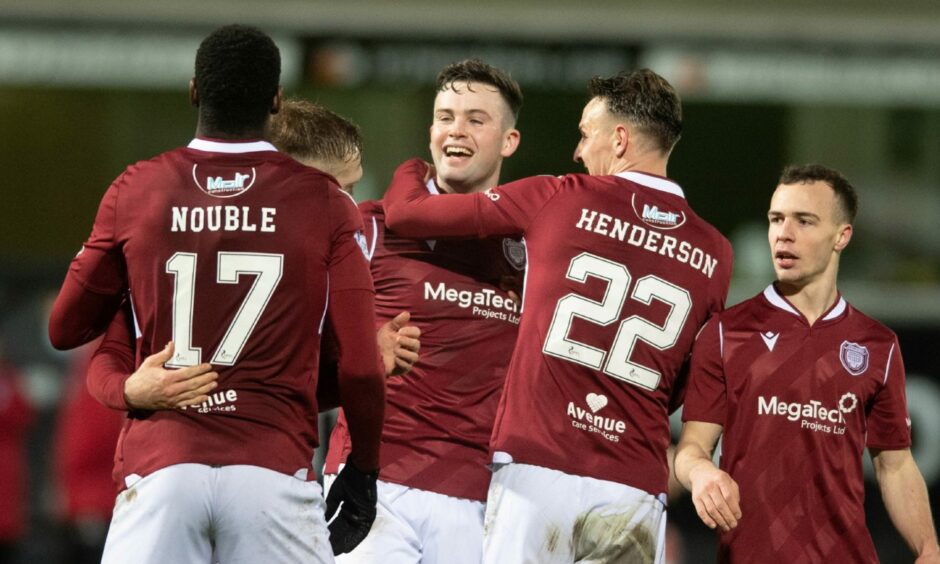 Anton Dowds congratulated by Liam Henderson and Joel Nouble after scoring against Dunfermline in December.