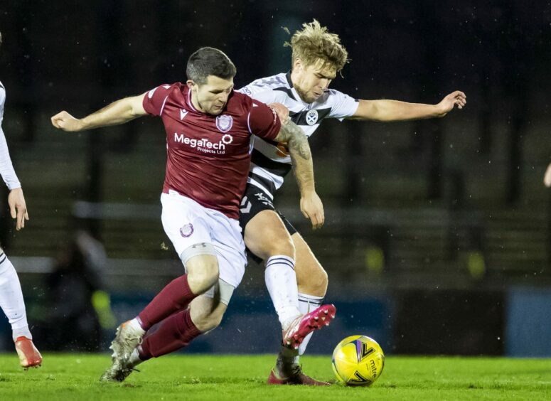 Dale Hilson battles for the ball with Ayr's Cameron Salkveld