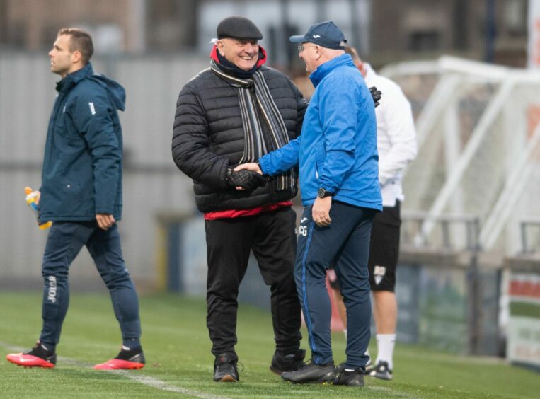 The two managers, Dick Campbell and John McGlynn, shake hands before kick off.