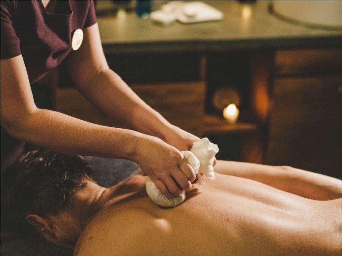 man getting massage before wedding at Old Course Hotel 