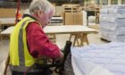 Employee at Dovetail Enterprises in Dundee making a mattress to order.