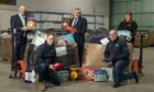 John Boumphrey, back left, Gordon Brown, centre and Paulinee Strachan, back right, with Amazon staff Simon McMahon, front left, Jamie Stain, bottom middle and Ben Robertson, bottom right, at the Lochgelly warehouse.