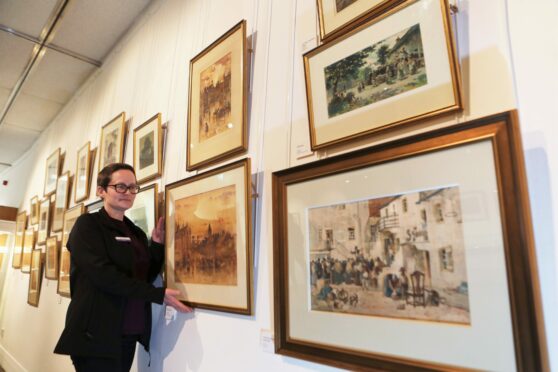 Visitor advisor Pauline Low with some of the works in the Meffan exhibition. Pic: Gareth Jennings/DCT Media.