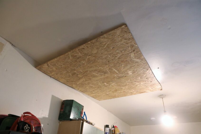 The piece of wood placed over the hole in the kitchen ceiling.