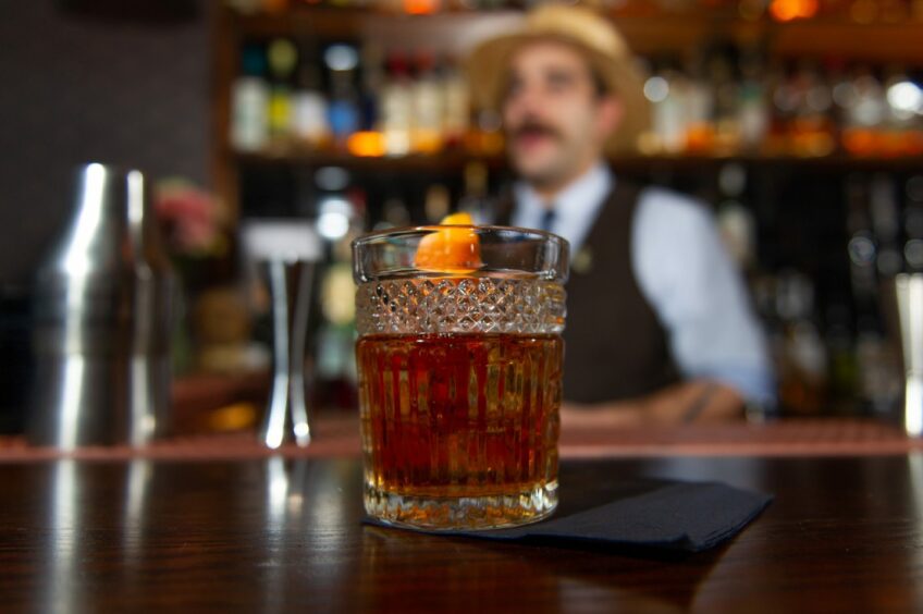 A cocktail sitting on the bar in The King of Islington.