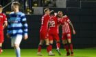 Rovers players rush to celebrate with Poplatnik