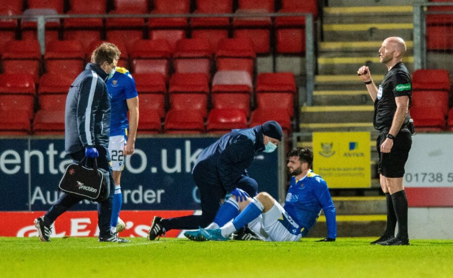 Nadir Ciftci receives treatment after hitting the deck early on against Dundee. 