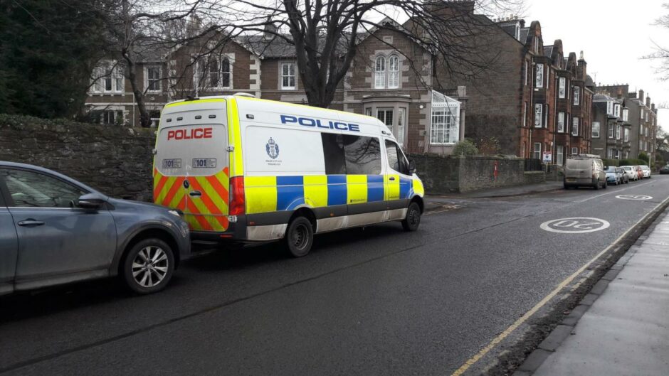 A police van near the area where officers are searching.