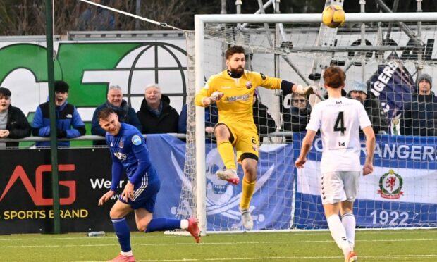 Aaron Lennox rushes out to clear the ball from Rory McAllister. The incident resulted in the Montrose keeper tearing his hamstring.