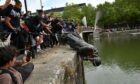 Protesters throw statue of Edward Colston into Bristol harbour. PA Photo.