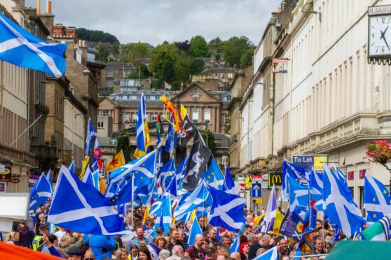 Saltires at an All Under One Banner march in Dundee in August 2018.