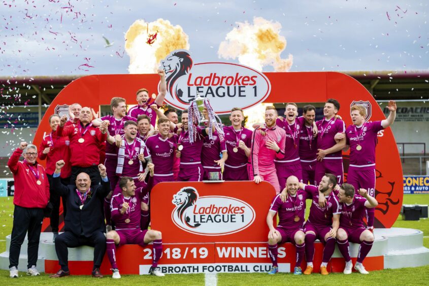 Swankie (third from right on stage) celebrates as part of the 2018/19 League One winning team.