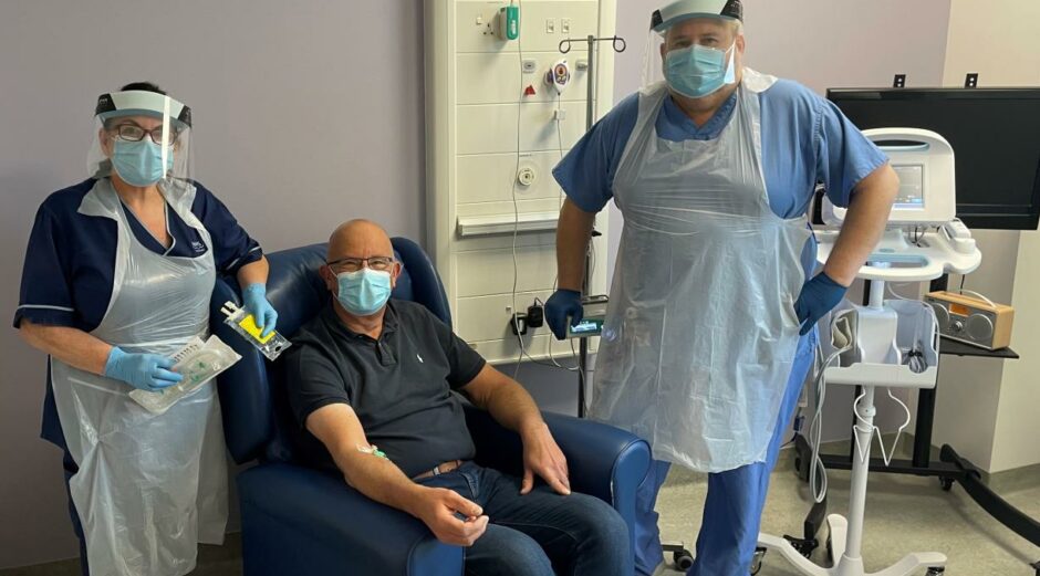 A Kirkcaldy man was first to receive treatment. He is pictured here with Senior Charge Nurse, Val Turner (left), and Staff Nurse, Wilson Imrie (right).