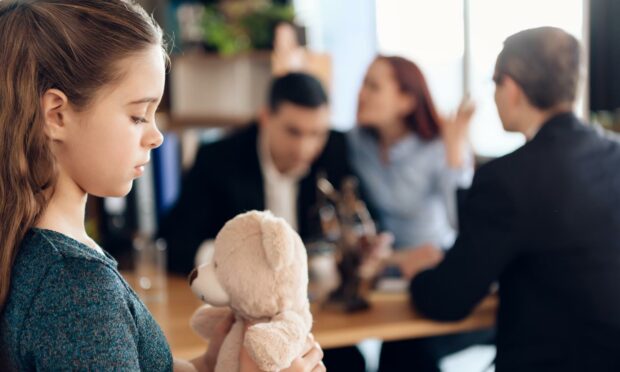 Divorce Day - young girl in lawyer's office with her parents.