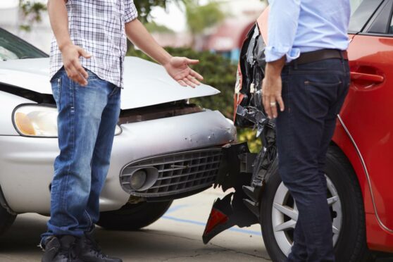 man arguing at car accident, saying I was in an accident and it wasn't my fault