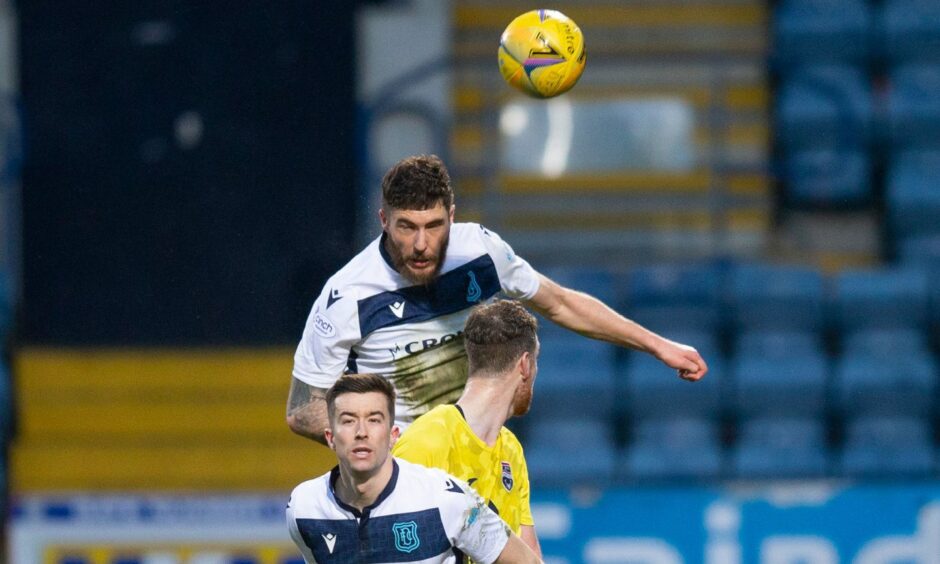 Defender Ryan Sweeney clears the danger for Dundee.