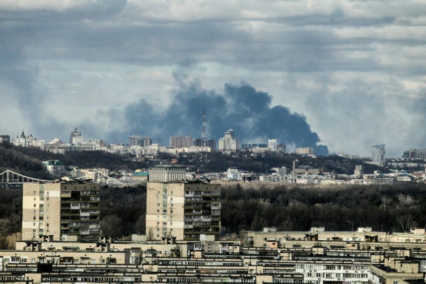 Smoke rises over the part of Ukraine's capital situated on the right bank of the Dnipro River on Sunday February 27