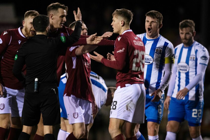 James Craigen pleads with referee David Munro after he was shown a red card for his challenge on Rory McKenzie.