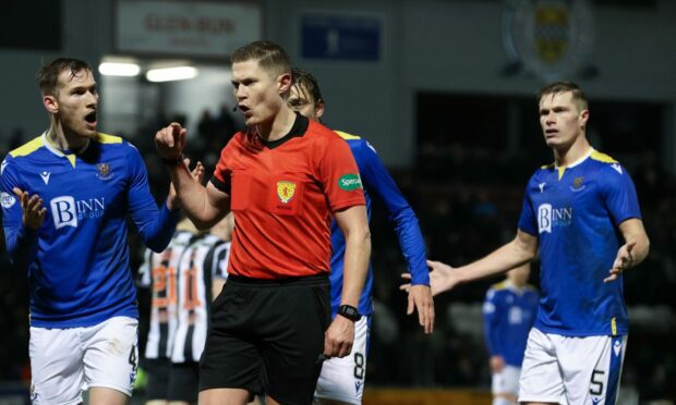 St Johnstone players complain to referee David Dickinson after he awards St Mirren a penalty.