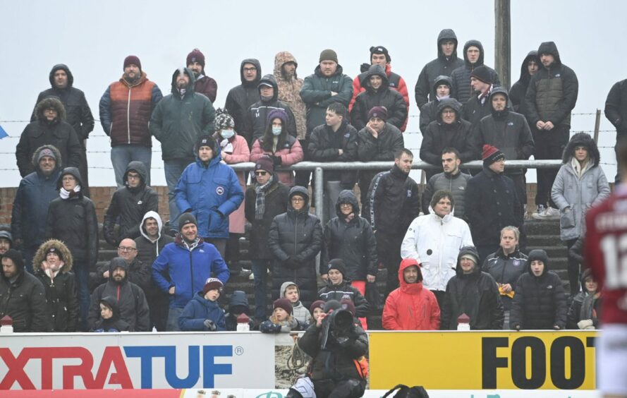 Some of the fans at a rain-soaked Gayfield