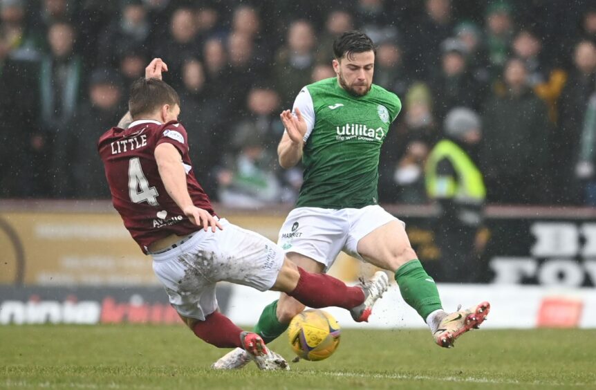 Ricky Little puts in a tackle on Hibs' Lewis Stevenson in his 300th start for Arbroath.