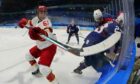 China's Wei Ruike  battles with United States' Brian Cooper during a preliminary round men's hockey game at the 2022 Winter Olympics. Picture by AP.
