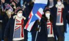 Eve Muirhead and Dave Ryding, of Britain, lead their team in during the opening ceremony of the 2022 Winter Olympics.
