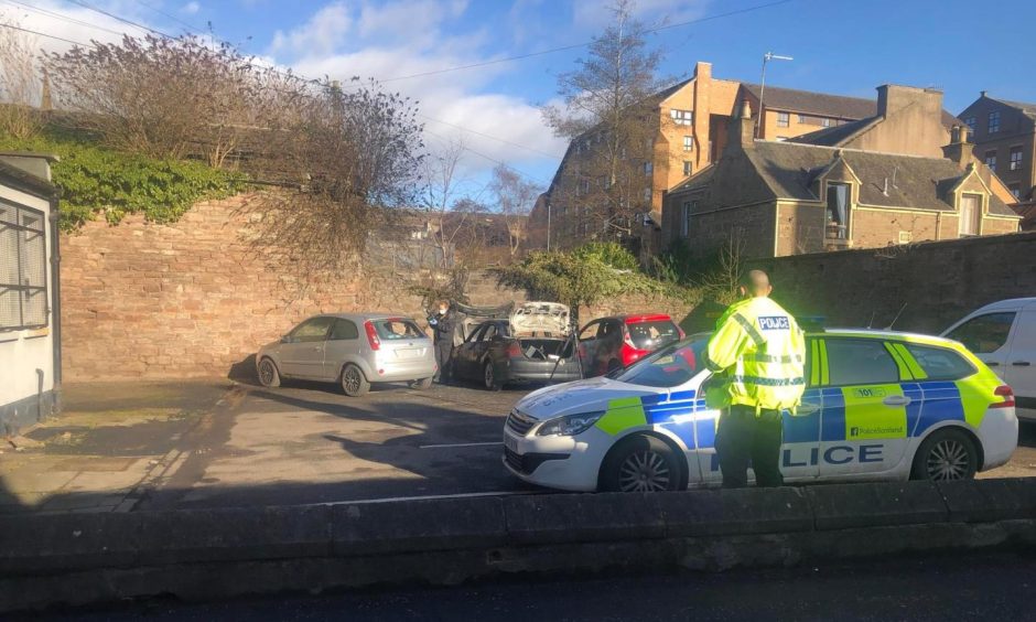 Police at the scene of the car fire in Lochee