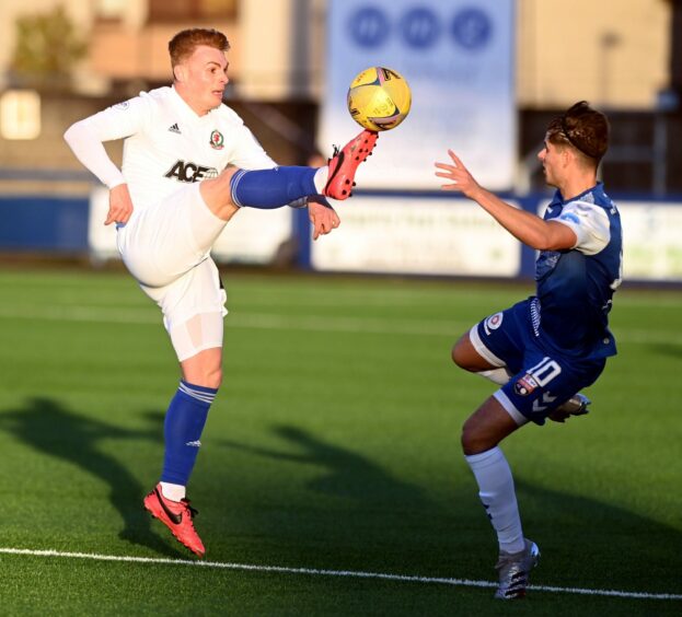 Lewis Milne in action against Cove in November, when he sustained his injury.