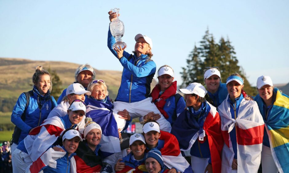 Team Europe captain Catriona Matthew celebrates with her team and the trophy after winning the 2019 Solheim Cup at Gleneagles.