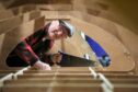 Ian Dickson of Forfar Men's Shed working on the St Ayles skiff. Pic: Gareth Jennings/DCT Media.