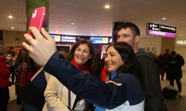Eve Muirhead has a selfie with mum, Lin and brother, Glen as she arrives at Edinburgh Airport.