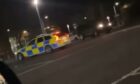 car does doughnuts around police in Fife