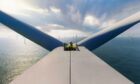 Engineer at top of offshore wind turbine in Scotland