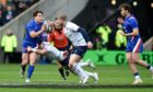 France's Antoine Dupont tries to skip past Ali Price and Finn Russell.