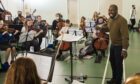 RSNO assistant conductor Kellen Gray leads Big Noise Douglas youngsters and RSNO musicians in rehearsals. Pic: Alan Richardson/Sistema Scotland.