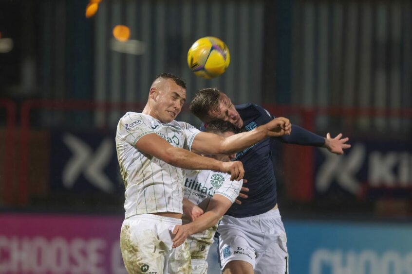 Lee Ashcroft challenges Hibs' Ryan Porteous in the 0-0 draw at Dens Park.