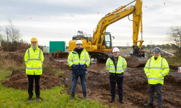 Steven Reid of SSE Renewables, Scott McCreadie, project manager at Nexans, Councillor David Fairweather, leader of Angus Council, and Maurice Dee, one of the workers on the cable installation team from Roadbridge.